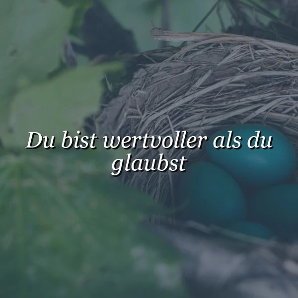 Ein gemütliches Vogelnest mit drei leuchtend türkisfarbenen Eiern, eingebettet in sattes grünes Laub, vermittelt eine sanfte Stimmung. Der inspirierende Spruch 'Du bist wertvoller als du glaubst' ist deutlich zu lesen und strahlt Mut aus.