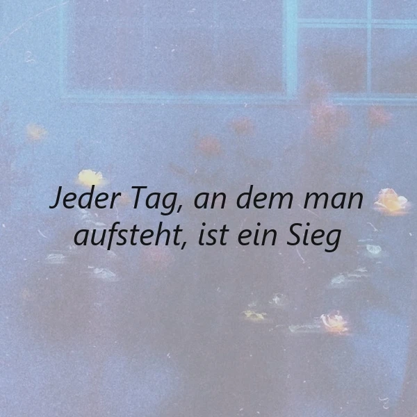 Ein ruhiges, blau getöntes Bild mit einem Fenster im Hintergrund und verstreuten Blättern, in dessen Mitte der Spruch 'Jeder Tag, an dem man aufsteht, ist ein Sieg' in schwarzer Schrift steht.
