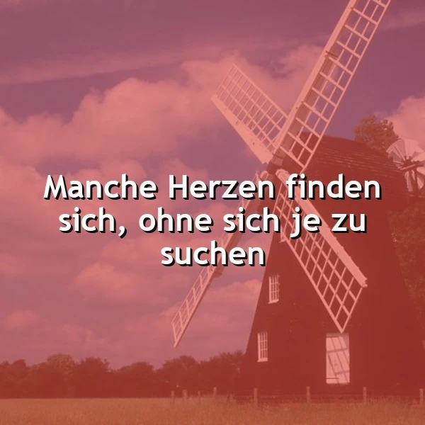 Ein romantisches Spruchbild mit einem alten Windmühle vor einem rosafarbenen Himmel bei Sonnenuntergang. Der weiße Text lautet: Manche Herzen finden sich, ohne sich je zu suchen. Es symbolisiert eine tiefe, unverhoffte Verbindung.